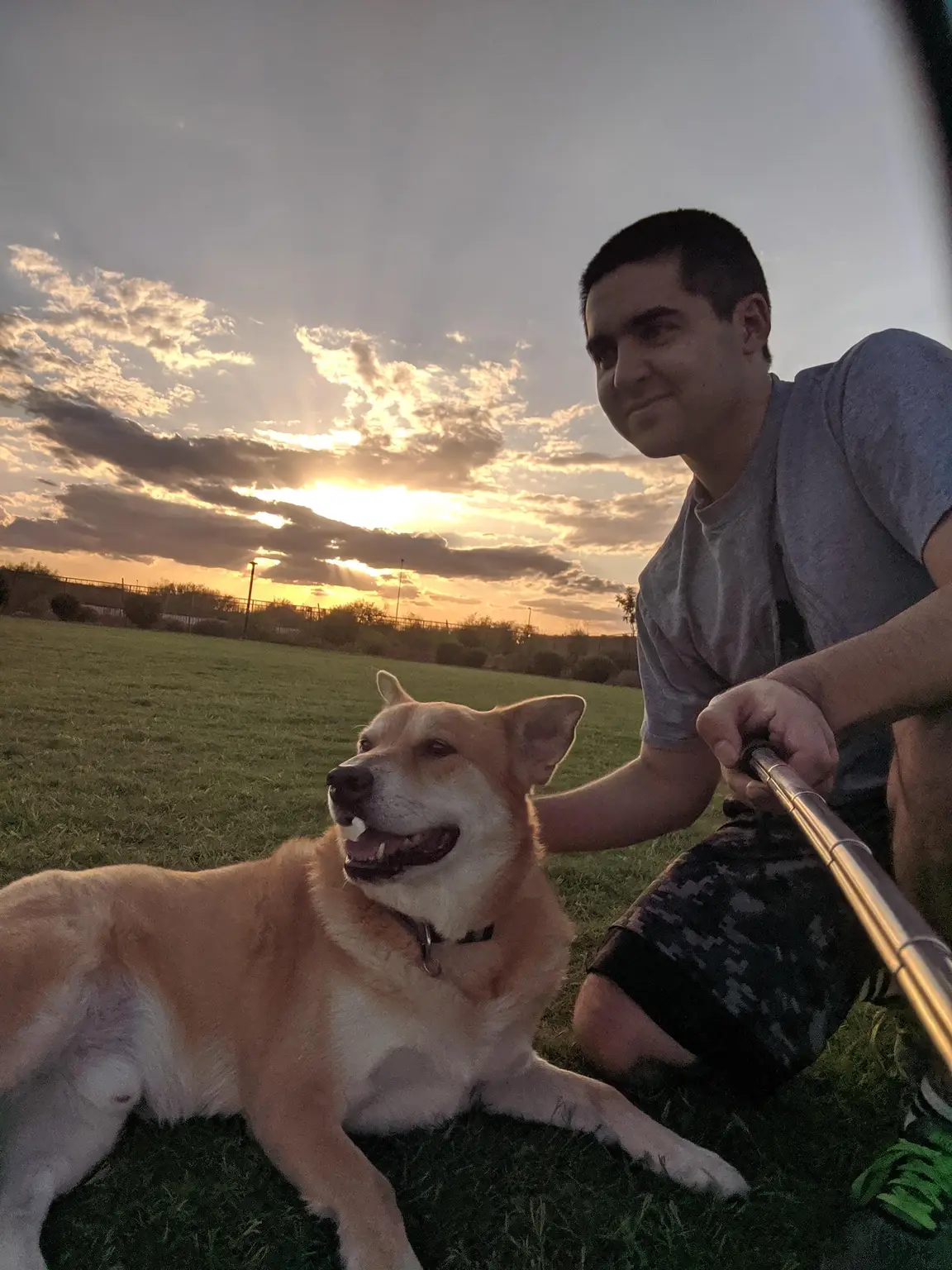 Alex relaxing outdoors with a happy dog in Ahwatukee